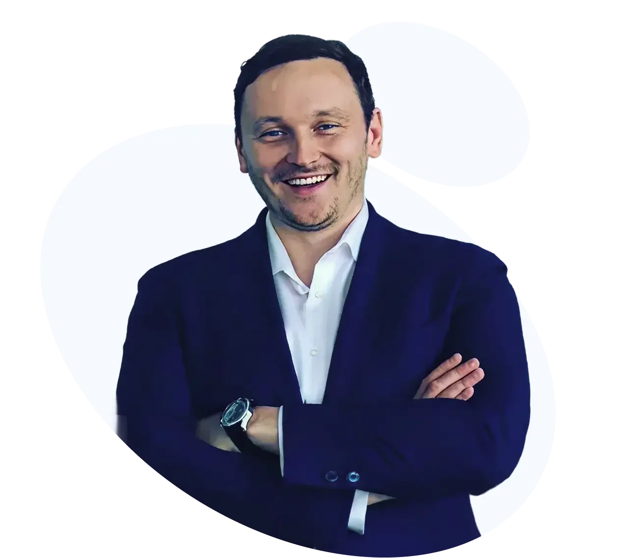 Anton Radchenko, founder of AirAdvisor, smiling in a navy suit with arms crossed